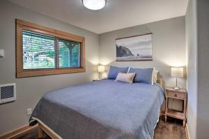 a bedroom with a blue bed and a window at Private Rockaway Beach Retreat 2 Blocks to Ocean! in Rockaway Beach