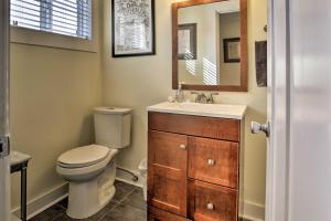 a bathroom with a toilet and a sink and a mirror at Private Rockaway Beach Retreat 2 Blocks to Ocean! in Rockaway Beach +19 photos