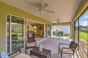 a screened in porch with chairs and a ceiling fan at Designer Home at The Villages - Near Brownwood in The Villages