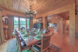 a dining room with a wooden table and chairs at Dream Catcher Luxe Cabin with Large Deck and Mtn View in Sapphire