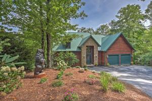 a house with a bear statue in a yard at Dream Catcher Luxe Cabin with Large Deck and Mtn View in Sapphire