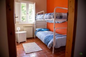A bed or beds in a room at Ca' le cerque, villa surrounded by the Marche nature