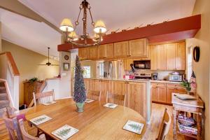 a kitchen with a wooden table with a christmas tree on it at Private Hot Tub and Deck Breckenridge Abode! in Breckenridge