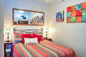 a bedroom with a bed and a mirror at Walkable Studio Apartment in Downtown Livingston! in Livingston