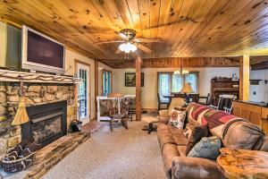a living room with a couch and a fireplace at Robbinsville Cabin with Deck 3 Mi to Fontana Lake! in Robbinsville