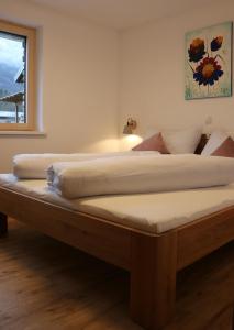 ein großes Bett in einem Zimmer mit Fenster in der Unterkunft Ferienhaus Raich in Vandans