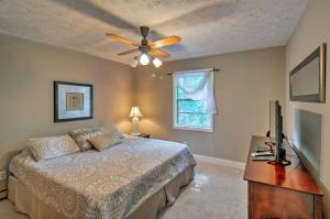 a bedroom with a bed and a ceiling fan at Spacious Georgia Getaway with Dock on Lake Lanier! in Gainesville