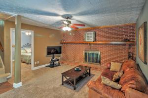 a living room with a brick fireplace and a couch at Spacious Georgia Getaway with Dock on Lake Lanier! in Gainesville