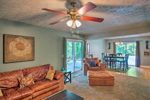 a living room with a couch and a ceiling fan at Spacious Georgia Getaway with Dock on Lake Lanier! in Gainesville