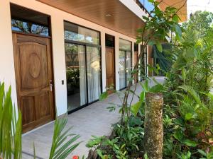 an entrance to a house with a wooden door at Hotel Manuel Antonio Park in Manuel Antonio