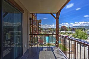 a balcony with chairs and a view of a city at Cozy Manson Condo on Lake Chelan with Pool Access! in Manson