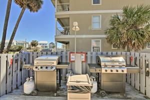 a group of grill equipment in front of a building at Emerald Hideaway Renovated Condo in Navarre Beach in Navarre