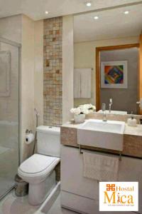 a bathroom with a white toilet and a sink at Hostal Mica in Abancay