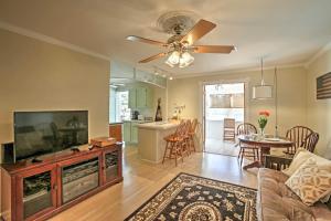 a living room with a couch and a flat screen tv at Bay St Louis House with Boat Dock and Launch! in Shoreline Park