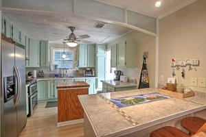 a kitchen with green cabinets and a counter top at Bay St Louis House with Boat Dock and Launch! in Shoreline Park