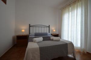 a bedroom with a bed with two towels on it at Apartamentos Solmares in Isla Canela