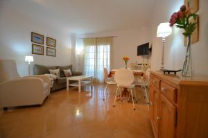 a living room with a couch and a table at Apartamentos Solmares in Isla Canela