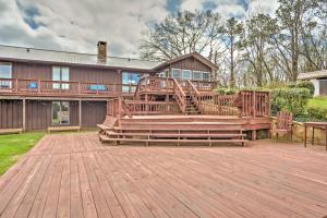 a home with a large deck with a house at Monticello Home with Multi-Level Deck on 2 and Acres! in Monticello