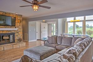 a living room with a couch and a fireplace at Monticello Home with Multi-Level Deck on 2 and Acres! in Monticello