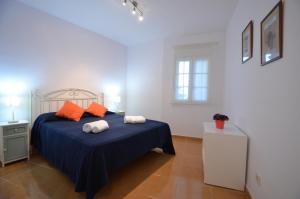a bedroom with a bed with two towels on it at Apartamentos Solmares in Isla Canela