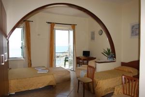 a room with two beds and a table and a window at Viviani Raffaella in Monterosso al Mare