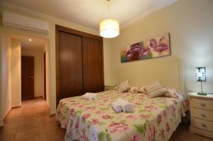 a bedroom with a bed with two towels on it at Apartamentos Solmares in Isla Canela