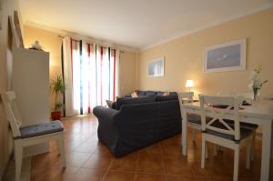 a living room with a couch and a table at Apartamentos Solmares in Isla Canela