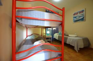 two bunk beds in a room with a bed at Apartamentos Solmares in Isla Canela