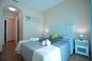 a bedroom with two beds with towels on them at Apartamentos Solmares in Isla Canela