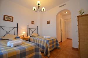 a bedroom with two beds in a room at Apartamentos Solmares in Isla Canela