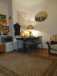 a dining room with a table and chairs and a lamp at Apartament City Center - 24 h contactless self check-in, no smoking, free bottled water, coffee and tea in Koszalin