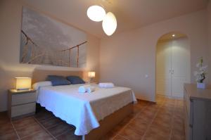 a bedroom with a bed with two towels on it at Apartamentos Solmares in Isla Canela