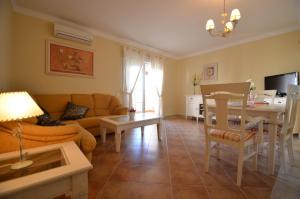 a living room with a couch and a table at Apartamentos Solmares in Isla Canela