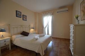 a bedroom with a bed with towels on it at Apartamentos Solmares in Isla Canela