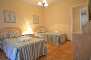 a hotel room with two beds with towels on them at Apartamentos Solmares in Isla Canela
