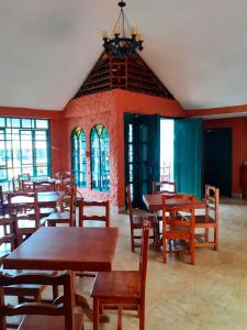 a dining room with wooden tables and chairs at CasKaffeSu Hotel and Restaurant Mindo in Mindo