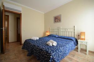 a bedroom with a bed with two towels on it at Apartamentos Solmares in Isla Canela