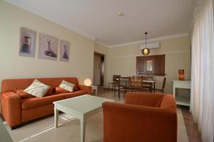 a living room with a couch and chairs and a table at Apartamentos Solmares in Isla Canela