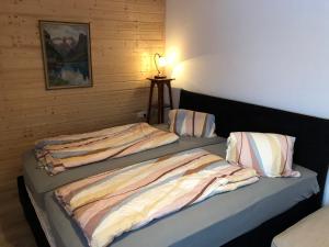 ein Schlafzimmer mit 2 Betten und einer Lampe auf einem Tisch in der Unterkunft Einser-Hütte Selbstversorgerhaus für 7 Personen in Vordernberg