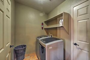 a small laundry room with a washing machine in it at Lake Havasu Getaway with Patio - Hike, Swim, and Golf! in Lake Havasu City +16 photos