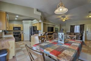 a kitchen and living room with a table and a kitchen and a dining room at Lake Havasu Getaway with Patio - Hike, Swim, and Golf! in Lake Havasu City