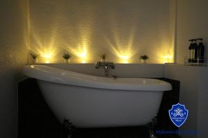 a white bath tub in a bathroom with lights at Mykonos Resort Miura / Vacation STAY 62210 in Yokosuka