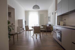 cocina y sala de estar con mesa y sillas en La casa di Nausicaa: il mito dell'ospitalità, en Reggio Calabria