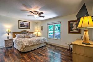 a bedroom with a bed and a ceiling fan at Arden Vacation Rental with Private Hot Tub and Grill! in Arden