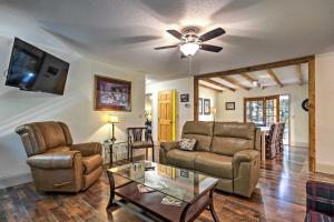 a living room with a couch and a table at Arden Vacation Rental with Private Hot Tub and Grill! in Arden