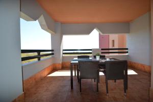 a dining room with a table and chairs on a balcony at Apartamentos Punta Canela in Isla Canela