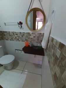 a bathroom with a sink and a mirror at Suíte da Vila - Beira Mar in Abraão +28 photos