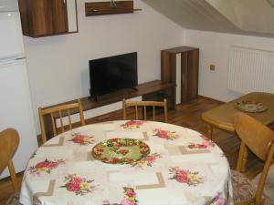 a dining room with a table with a plate on it at Chalupa Erika in Dobšín