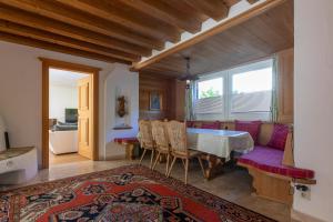 a living room with a table and a couch at Ahorn Chalet in Mayrhofen