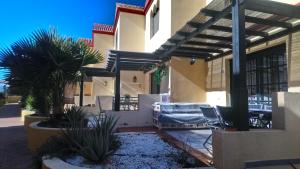 a house with a patio with plants in front of it at fuerte blue in Costa Calma
